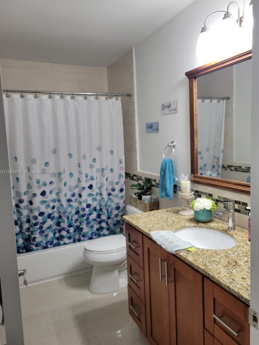8245 Southwest 43rd Street Miami, FL 33155 - Photo 10 of 24 a bathroom with a granite countertop sink and a mirror