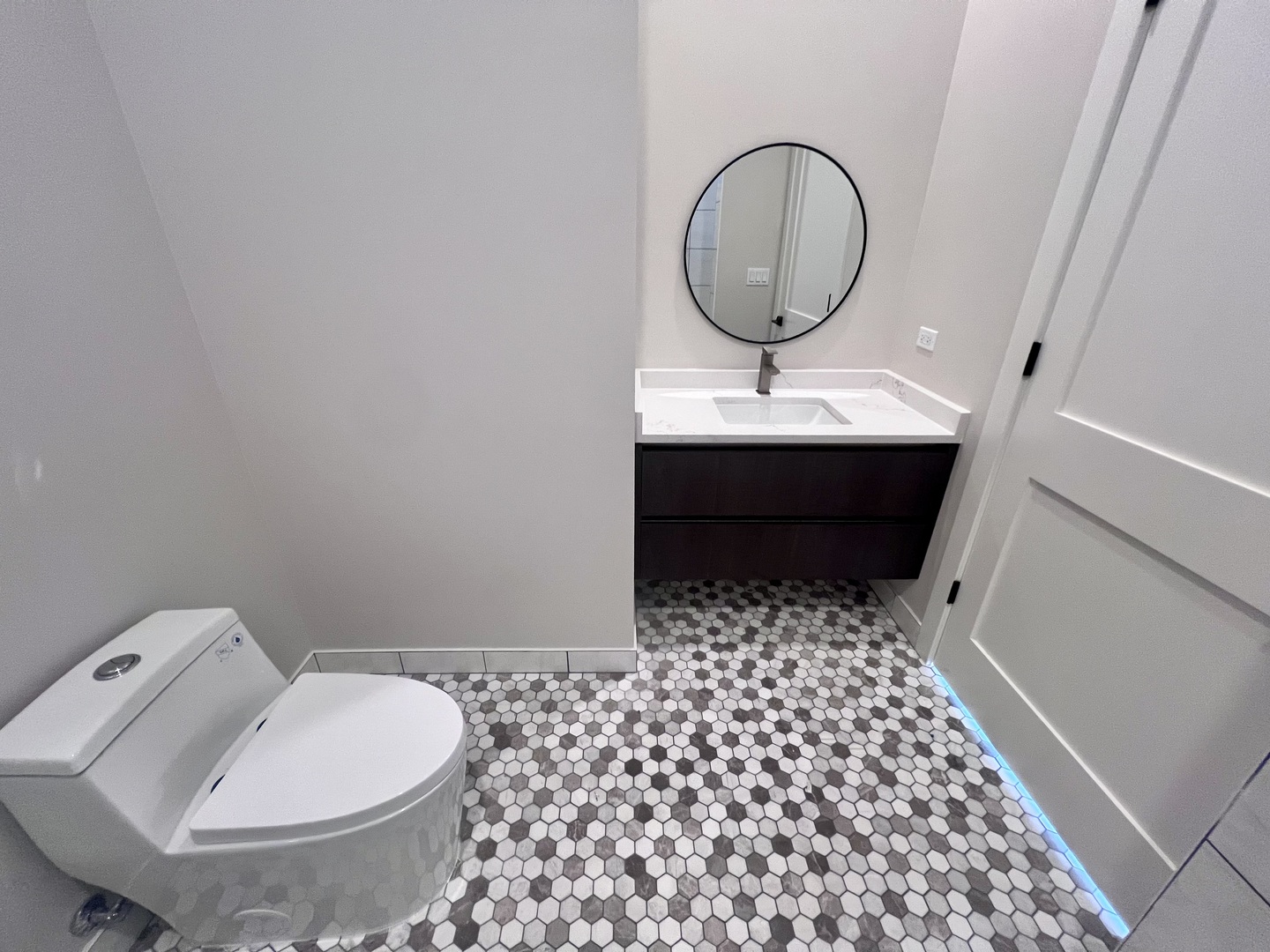 1039 West Belmont Avenue, Unit 4 Chicago, IL 60657 - Photo 16 of 22 a bathroom with a sink a toilet and a mirror