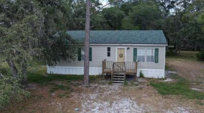 1155 Northeast 342nd Trail Okeechobee, FL 34972 - Photo 2 of 7 a view of a house with a yard and tree
