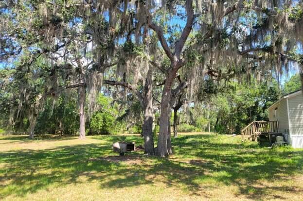 1155 Northeast 342nd Trail Okeechobee, FL 34972 - Photo 3 of 7 a view of outdoor space with deck and trees