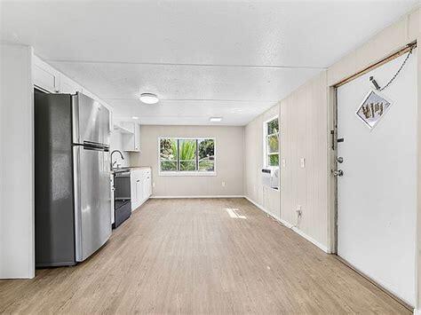 1155 Northeast 342nd Trail Okeechobee, FL 34972 - Photo 7 of 7 a view of a refrigerator in kitchen and wooden floor