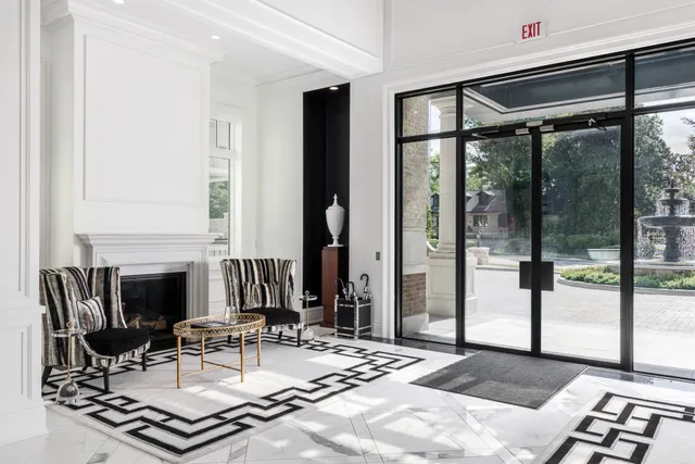 a living room with fireplace furniture and a floor to ceiling window