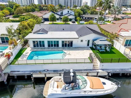 a dining room with furniture a floor to ceiling window and chairs