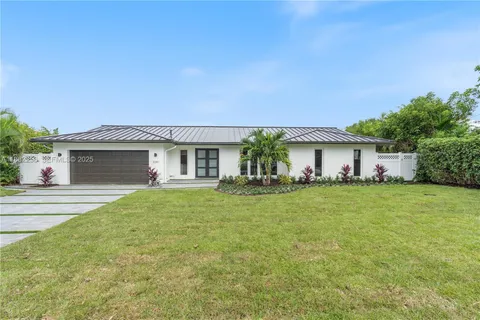 a kitchen with a sink a stove and cabinets