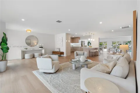 a dining room with furniture a floor to ceiling window and chairs