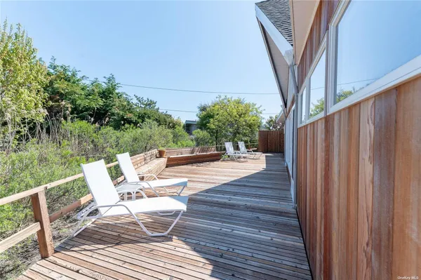 a view of balcony with furniture and trees