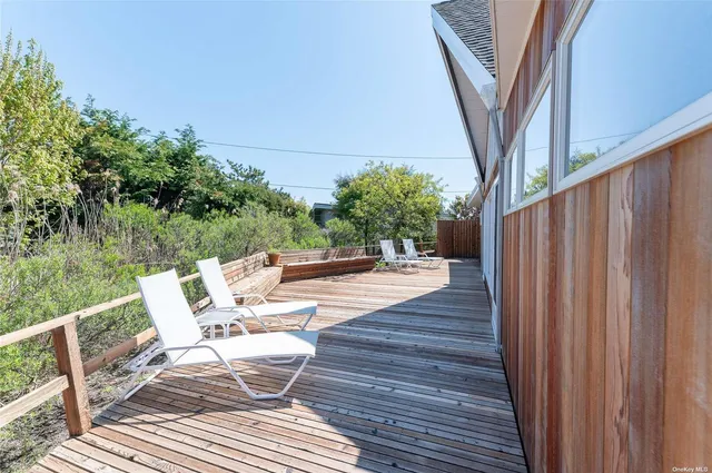 a view of balcony with furniture and trees