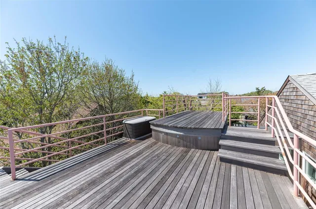 a view of a balcony with wooden floor and city view