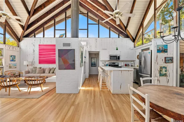 a open kitchen with stainless steel appliances granite countertop a stove and a refrigerator