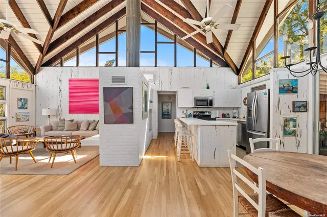 a open kitchen with stainless steel appliances granite countertop a stove and a refrigerator