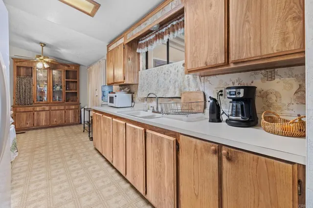 a kitchen with stainless steel appliances granite countertop a sink and cabinets