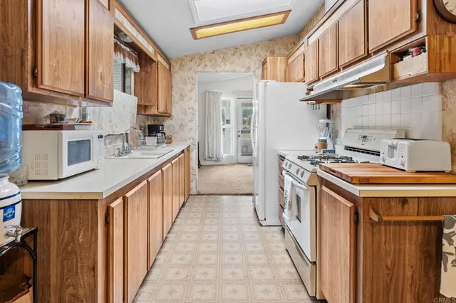 a kitchen with stainless steel appliances granite countertop a stove and a refrigerator