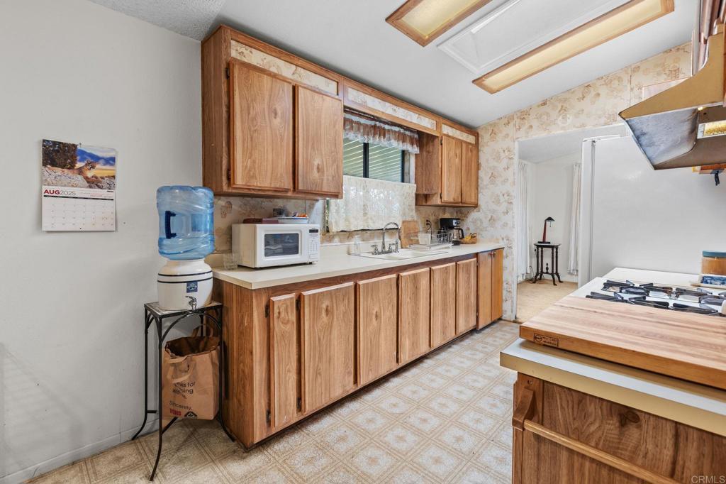 28890 Lilac Road, Unit 160 Valley Center, CA 92082 - Photo 15 of 30 a kitchen with stainless steel appliances granite countertop a sink stove and cabinets