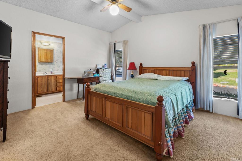 28890 Lilac Road, Unit 160 Valley Center, CA 92082 - Photo 20 of 30 a bedroom with a bed and a chandelier