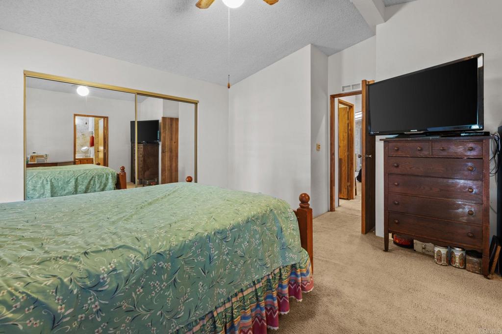 28890 Lilac Road, Unit 160 Valley Center, CA 92082 - Photo 21 of 30 a bedroom with a bed and a flat screen tv