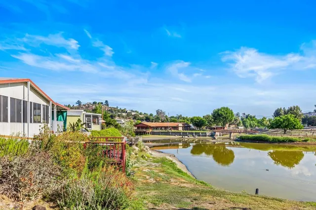 a view of a lake with houses in the back