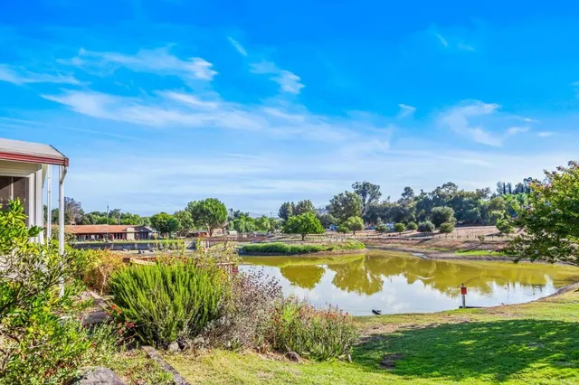 a view of a lake with houses in the back