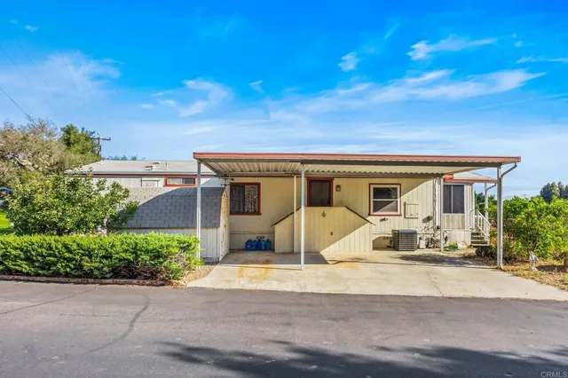 a view of a white house with swimming pool in front of it