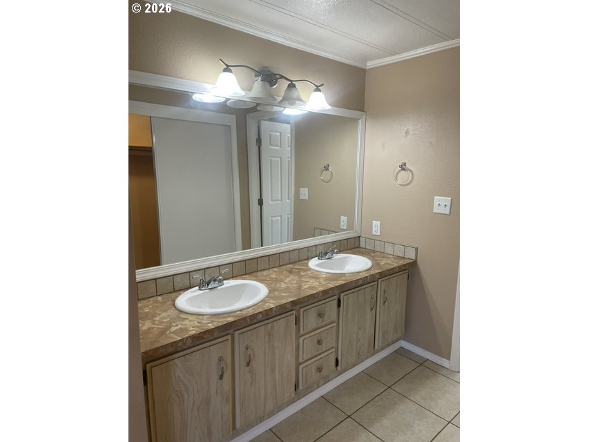 5660 Daisy Street, Unit 31 Springfield, OR 97478 - Photo 24 of 44 a bathroom with a granite countertop sink and a mirror