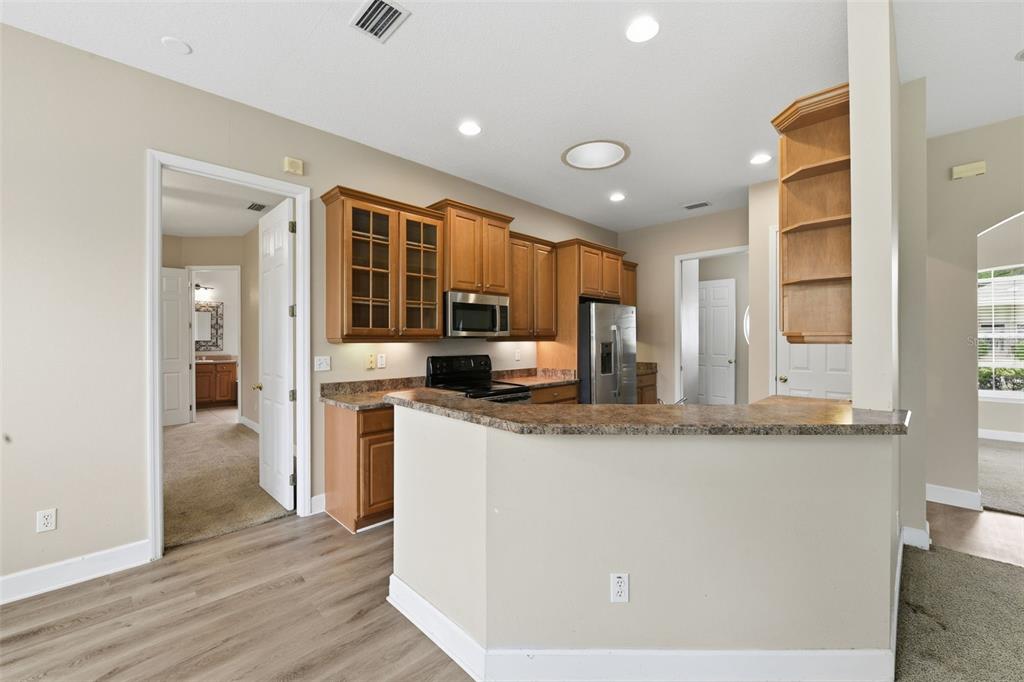 609 Renner Road Port Orange, FL 32127 - Photo 11 of 37 a kitchen with stainless steel appliances granite countertop a sink and a refrigerator