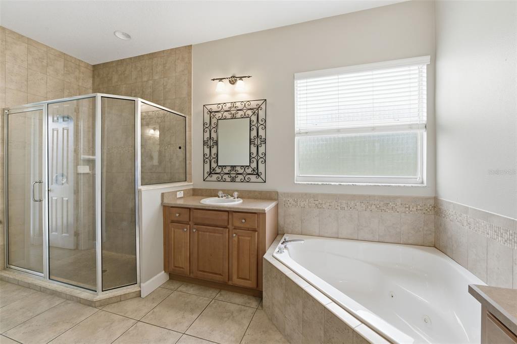 609 Renner Road Port Orange, FL 32127 - Photo 24 of 37 a bathroom with a tub a sink and a mirror