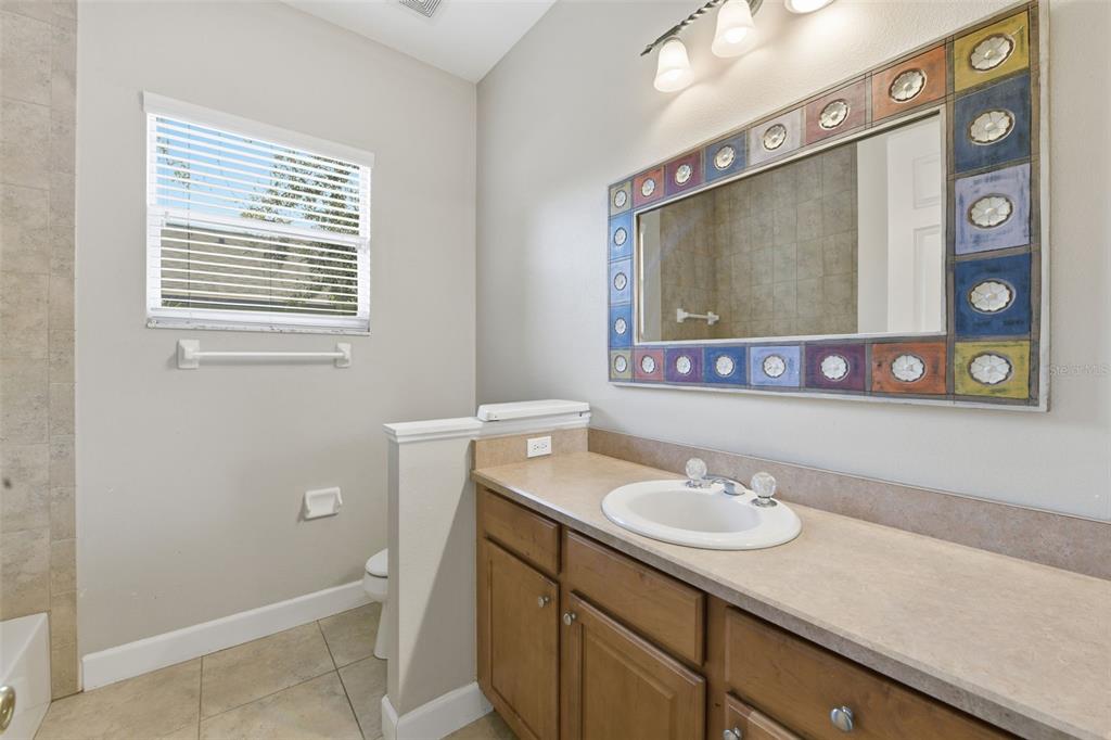 609 Renner Road Port Orange, FL 32127 - Photo 26 of 37 a bathroom with a sink a mirror and a toilet