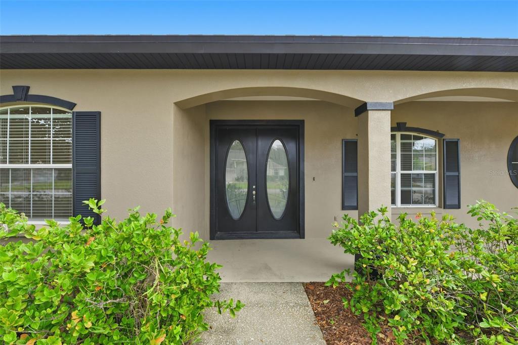 609 Renner Road Port Orange, FL 32127 - Photo 4 of 37 a front view of a house with a lots of plants
