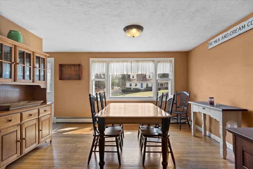 136 Winthrop Lane Holden, MA 01520 - Photo 11 of 42 a view of a dining room with furniture window and wooden floor