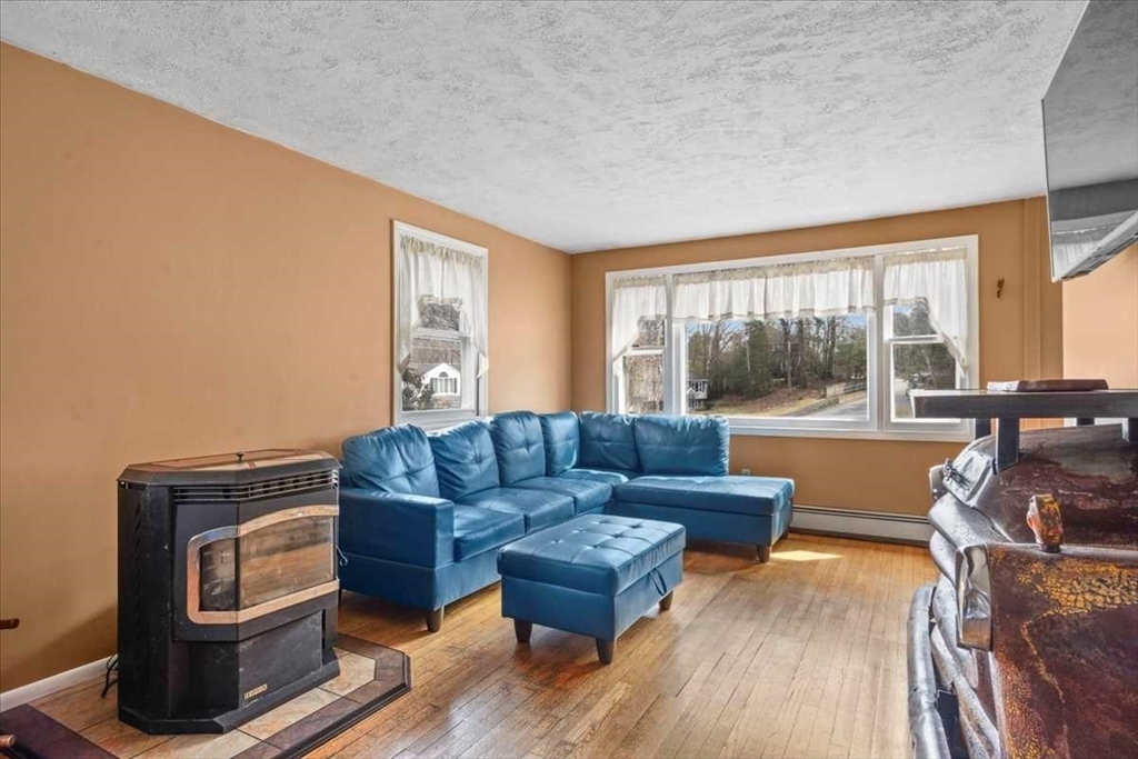 136 Winthrop Lane Holden, MA 01520 - Photo 16 of 42 a living room with furniture and a floor to ceiling window