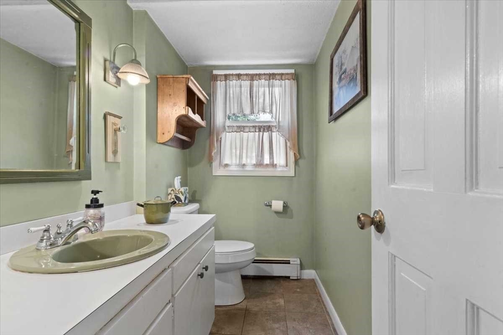 136 Winthrop Lane Holden, MA 01520 - Photo 20 of 42 a bathroom with a sink and mirror with toilet