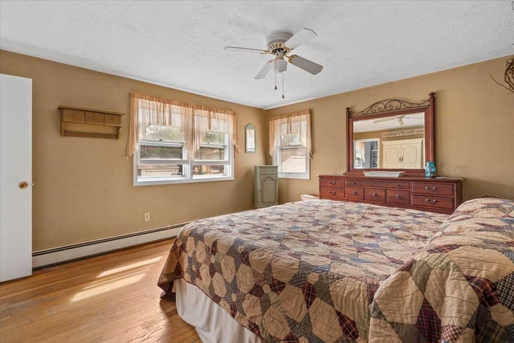 136 Winthrop Lane Holden, MA 01520 - Photo 21 of 42 a bedroom with a large bed and a window