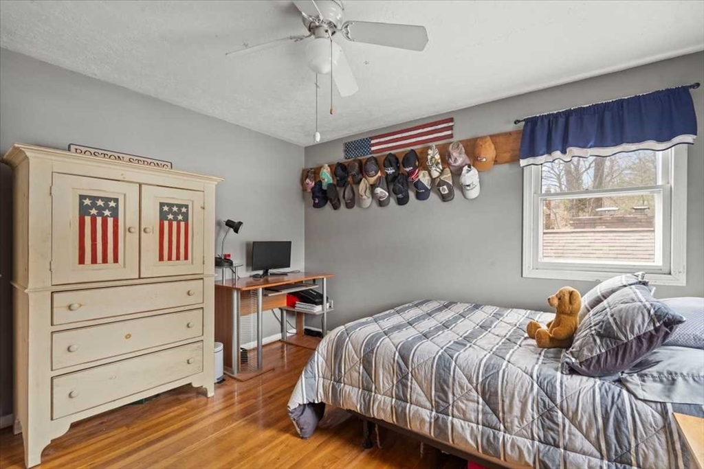 136 Winthrop Lane Holden, MA 01520 - Photo 24 of 42 a bedroom with a bed and wooden floor