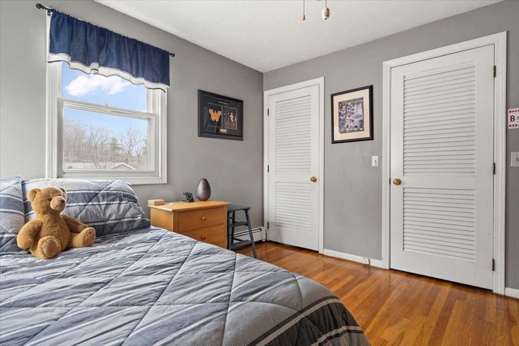 136 Winthrop Lane Holden, MA 01520 - Photo 26 of 42 a bedroom with a bed and wooden floor
