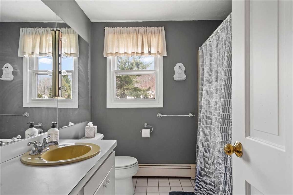 136 Winthrop Lane Holden, MA 01520 - Photo 27 of 42 a bathroom with a toilet a sink and a mirror