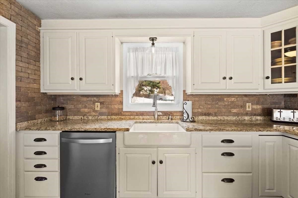 136 Winthrop Lane Holden, MA 01520 - Photo 8 of 42 a kitchen with granite countertop white cabinets and window