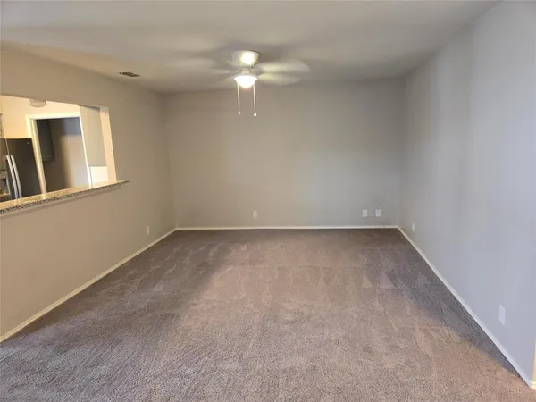 a kitchen with stainless steel appliances granite countertop a stove top oven a sink dishwasher and a refrigerator