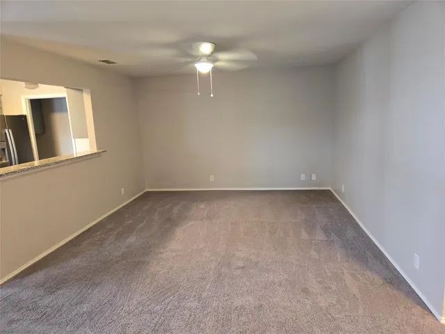 a kitchen with stainless steel appliances granite countertop a stove top oven a sink dishwasher and a refrigerator