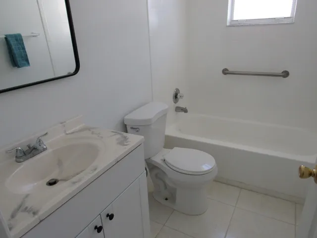a white bath tub sitting next to a window