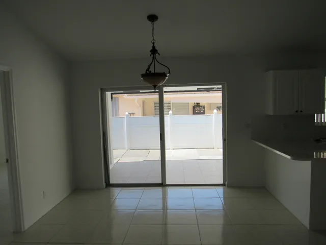 a kitchen with a refrigerator and window
