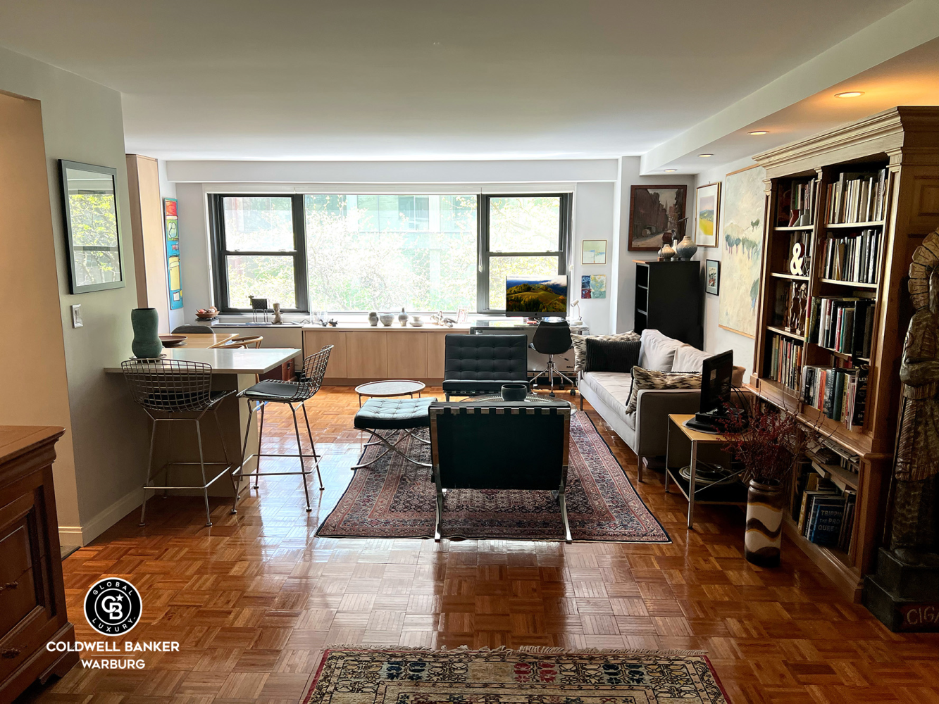 1065 Park Avenue, Unit 3B Manhattan, NY 10128 - Photo 13 of 18 a living room with furniture and a book shelf