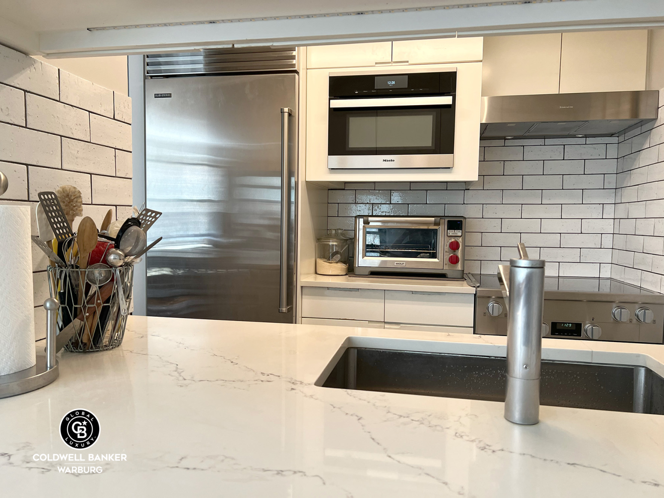1065 Park Avenue, Unit 3B Manhattan, NY 10128 - Photo 14 of 18 a view of a refrigerator and microwave in a kitchen