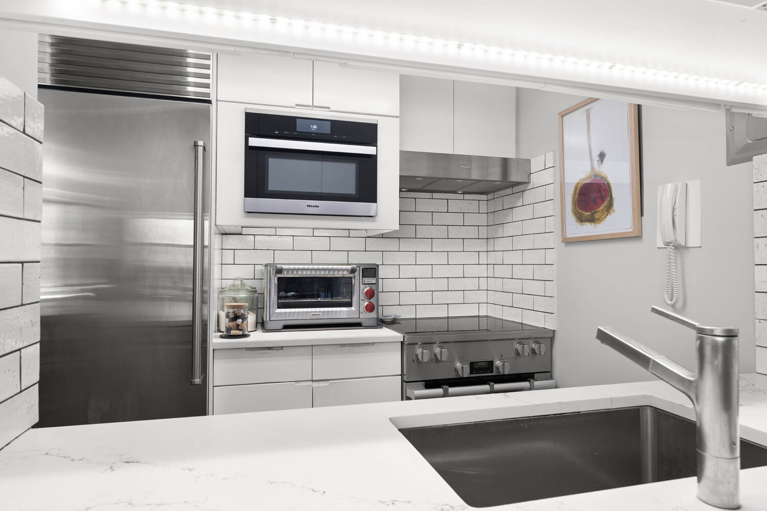 1065 Park Avenue, Unit 3B Manhattan, NY 10128 - Photo 4 of 18 a kitchen with stainless steel appliances kitchen island a stove and a microwave