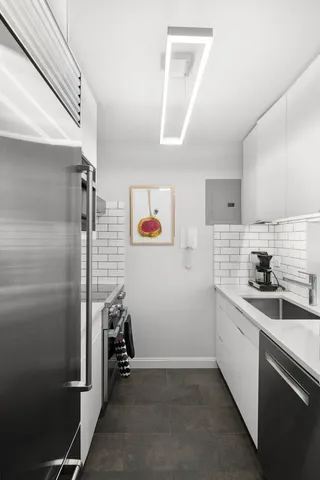 a kitchen with stainless steel appliances kitchen island a stove and a microwave