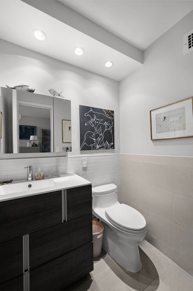1065 Park Avenue, Unit 3B Manhattan, NY 10128 - Photo 7 of 18 a bathroom with a toilet sink and mirror
