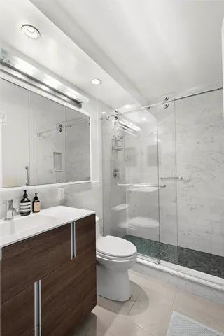 a bathroom with a toilet sink and mirror