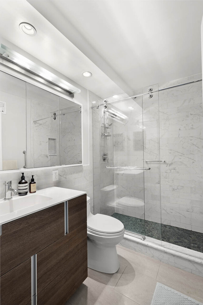 1065 Park Avenue, Unit 3B Manhattan, NY 10128 - Photo 8 of 18 a bathroom with a sink a toilet and shower