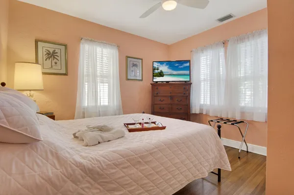 a bedroom with a bed and wooden floor