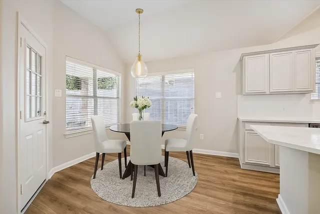 a view of a dining room with furniture window and wooden floor
