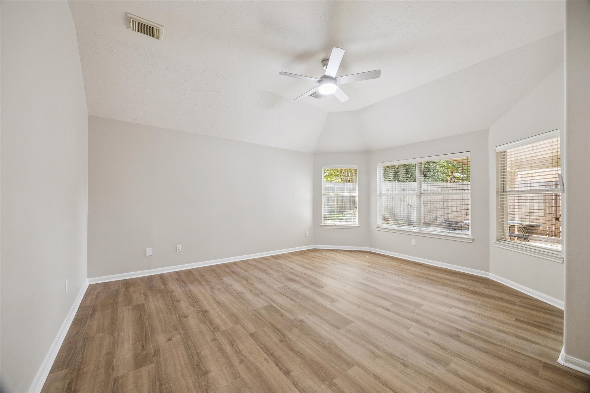 18747 Candle Park Drive Spring, TX 77388 - Photo 17 of 32 a view of an empty room with a window and wooden floor
