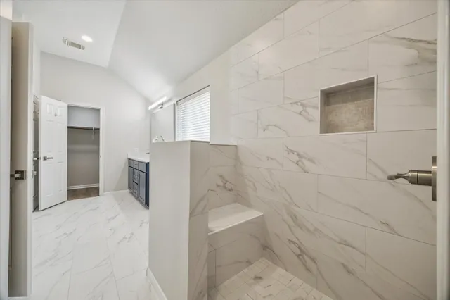 a bathroom with a bathtub and a shower